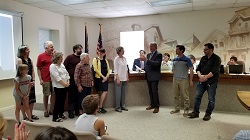 Doylestown Mayor Ron Strouse with Doylestown Bookshop staff and family at the Bourough's Council meeting. Photo credit: Colleen Dunn. 